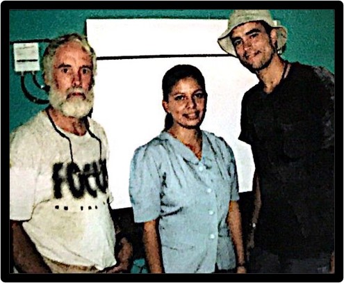 Ann - Scanned photo of Allen at first solar project in 2000, with clinic nurse and Tony Neff